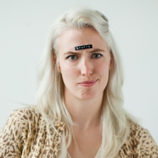 Portrait of young woman with word stupid on forehead. Photo : Jessica Peterson
