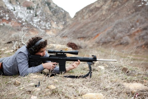 USA, Utah, Spanish Fork. Man lying on front with weapon. Photo : Jessica Peterson