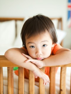 Portrait of girl leaning on bed frame (2-3). Photo : Jessica Peterson