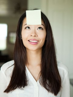 Portrait of young woman with adhesive note stuck to her forehead. Photo : Jessica Peterson