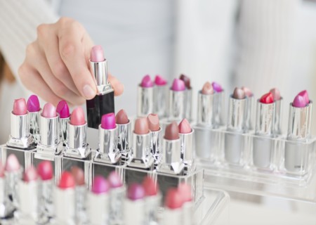 Hand of woman choosing lipstick.