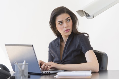 Businesswoman spied on by cctv camera.