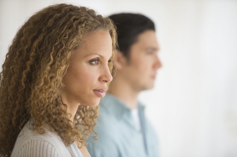 Profile of couple with focus on woman in foreground.
