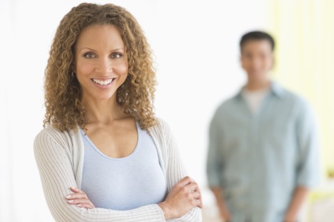 Portrait of couple with focus on woman in foreground.