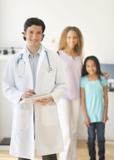 Doctor with patients (woman and girl aged 12-13) in office.