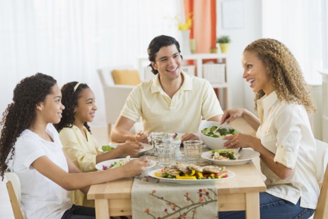 Parents with daughters (10-13) eating dinner.