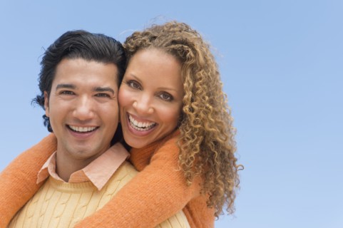 Portrait of couple against blue sky.