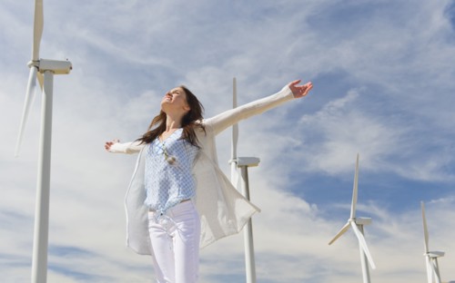 Young woman at wind farm.
