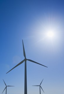 Wind turbine against blue sky.