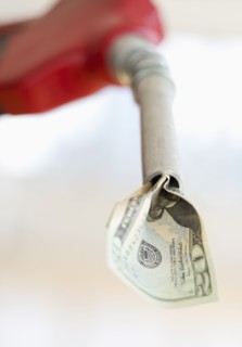 Fuel nozzle with dollar bill.