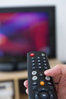 Hand using remote control.