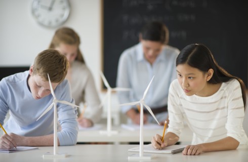 Students (14-19) examining wind turbines.