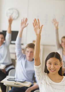 Students (14-19) raising hands.