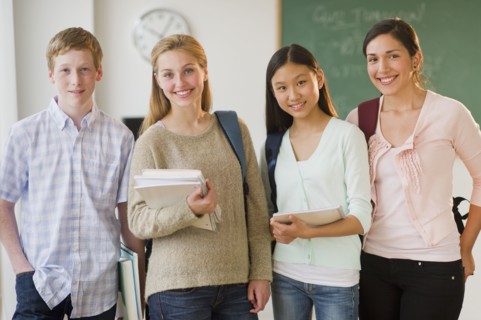 Portrait of students (14-19) in classroom.