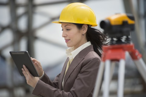 Architect using digital tablet in construction site.