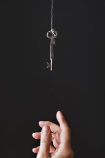 Hand reaching for key.