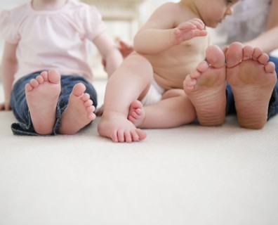 Feet of mother and children (6-11 months, 2-3). 
Photo: Jamie Grill