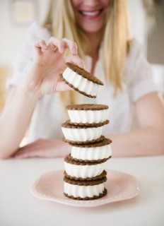 Woman enjoying ice cream sandwich. 
Photo : Jamie Grill
