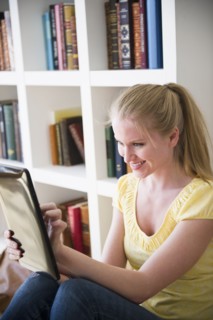 Woman using digital tablet. 
Photo : Jamie Grill