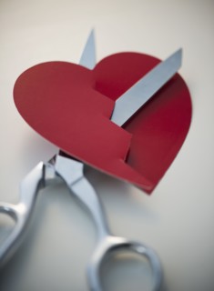 Scissors cutting paper heart. 
Photo: Jamie Grill