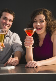 Couple sitting at bar counter and enjoying drinks. 
Photo : Jamie Grill