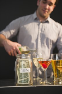 Bar tender pouring wine into glass. 
Photo : Jamie Grill