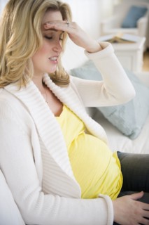 Pregnant woman with head in hands. 
Photo : Jamie Grill