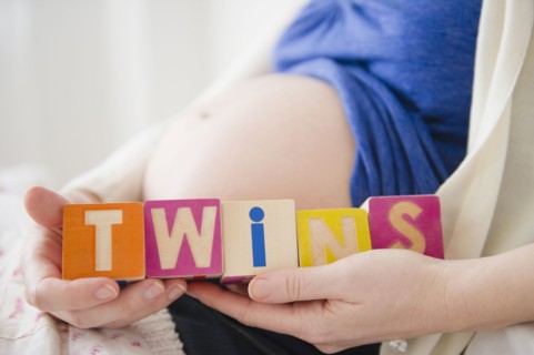 Pregnant woman holding wooden blocks . 
Photo : Jamie Grill