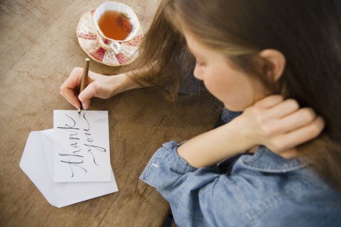 Woman writing greeting card. 
Photo : Jamie Grill