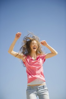 Happy woman jumping outdoors. 
Photo : Jamie Grill
