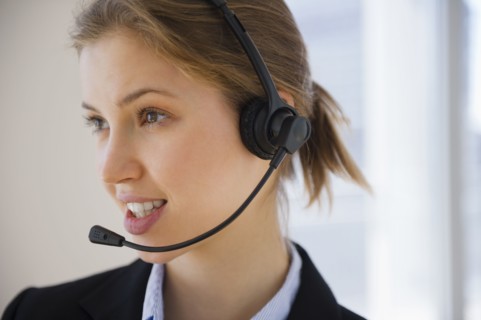 Customer service representative with headset. 
Photo : Jamie Grill