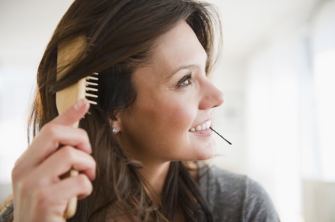 Woman brushing hair. 
Photo: Jamie Grill