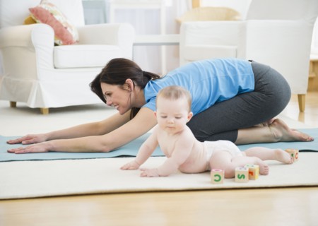 Mother with baby daughter (6-11 months) practicing yoga. 
Photo : Jamie Grill