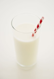 Close up of glass of milk with straw. 
Photo : Jamie Grill