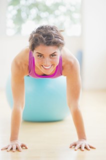 Woman exercising on fitness ball. 
Photo : Daniel Grill