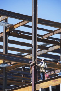 Construction workers on construction frame. 
Photo : fotog