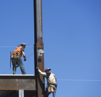 Construction workers on construction frame. 
Photo : fotog