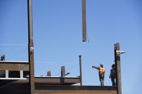 Construction workers on construction frame. 
Photo : fotog