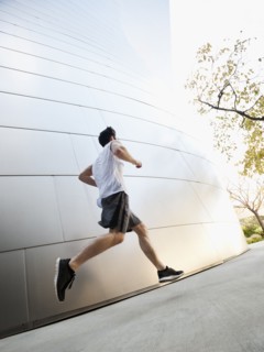 USA, California, Los Angeles, Young man running on city street.