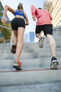 USA, California, Los Angeles, Young man and young woman running on city street. 
Photo: Erik