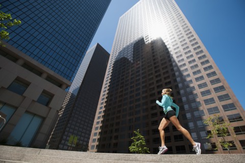 USA, California, Los Angeles, Young woman running in city.