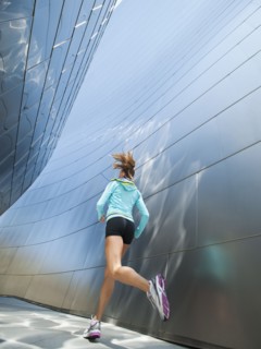 USA, California, Los Angeles, Young woman jogging in city.