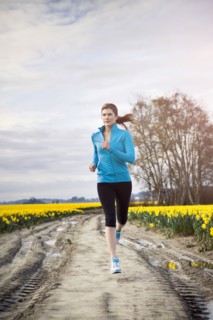 USA, Washington, Skagit Valley, Woman running in rural area. 
Photo: Take A Pix Media