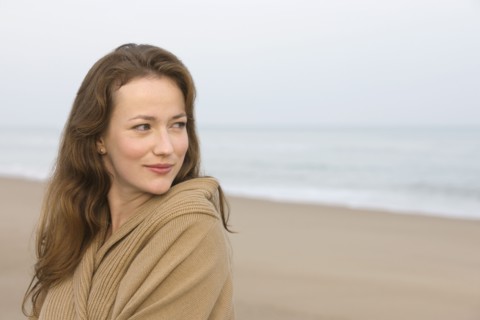 Young woman on empty beach. 
Photo : Jan Scherders