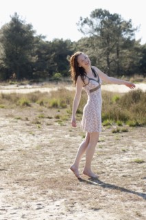 Belgium, Kalmthoutse Heide, Young woman walking barefoot. 
Photo : Jan Scherders
