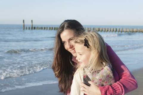 Netherlands, Zeeland, Haamstede, Mother with daughter on beach. 
Photo: Jan Scherders