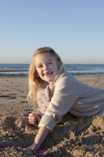 Netherlands, Zeeland, Haamstede, Girl digging sand on beach. 
Photo: Jan Scherders