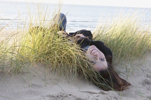 Netherlands, Zeeland, Haamstede, Woman lying on sand dune. 
Photo: Jan Scherders