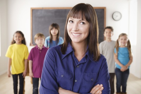 Teacher with group of pupils in front of blackboard. 
Photo : Rob Lewine