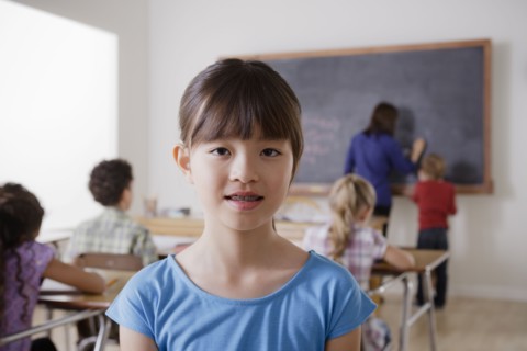 Portrait of schoolgirl in classroom. 
Photo : Rob Lewine